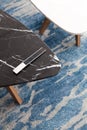 Two modern stool made of black and white artificial stone stands on a carpet with fine nap, a top view. Royalty Free Stock Photo