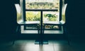 Two modern style chairs near the cute little table near the window with brick wall black and white interior shot Royalty Free Stock Photo