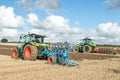 Two Modern tractors pulling ploughs Royalty Free Stock Photo
