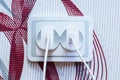 Two modern white cell phone chargers plugged into the socket. Energy waste concept.