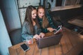 Two modern women having meeting in cafe. working on laptop ant tablet Royalty Free Stock Photo