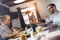 Two modern young businessman sit around table and work on laptop Royalty Free Stock Photo