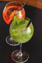 Two mojito alcohol cocktails with plastic straw, tropical beverage with ice, mint and lime, copy space. Royalty Free Stock Photo