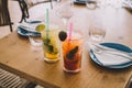 Two mojito cocktails made with aged rum, mint, and different fruits.