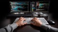 Two monitors display colorful lines of code as hands type on a keyboard, showcasing a focused programming session in a Royalty Free Stock Photo