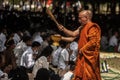 Two Monks broadcasting holy water to the people