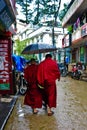 Two monks with umbrella in Dharamsala, India