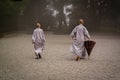 Two monks with umbrella at the morning prayer.