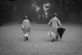 Two monks with umbrella at the morning prayer.