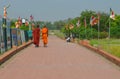 Two Monks are walking on road in Lumbini, Nepal - birthplace of Buddha.