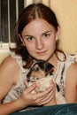 Red-haired girl holding a puppy Jack Russell. Royalty Free Stock Photo