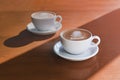 Two morning cups of coffee on wooden background