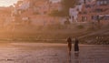 Two Moroccan women walkind into the glowing sunset