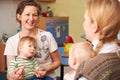 Two Mothers With Children Chatting At Playgroup Royalty Free Stock Photo