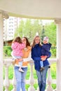 Two mothers with children on the walk in gazebo