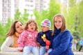 Two mothers with children on the walk in gazebo