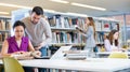 Two male and female students studying together in library Royalty Free Stock Photo