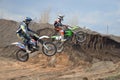 Two motocross riders on a motorbike jumps Royalty Free Stock Photo