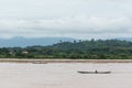 Two motor boats collect logs in the river after flood