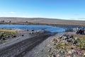 Two motorbike tourists thinking how to cross the river to continue F910 road in Central Highlands of Iceland