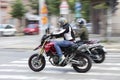 Two motorbikes sppeding on the city street