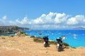 02.09.2018. Two motorcycles on the top of the rock cliff and paradise clear torquoise blue water with boats and cloudy blue sky in Royalty Free Stock Photo