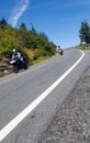 Two motorcyclists coming down a mountain road