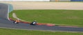 Two motorcyclists on the highway in steep bend