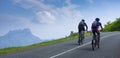 Two mountain bikers riding bike in road