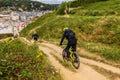 Two mountain bikers wearing safety gears going downhill, Etretat, France Royalty Free Stock Photo