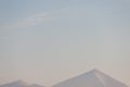 Two mountain peaks covered with snow