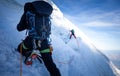 Two mountaineers climb steep glacier ice crevasse extreme sports, Mont Blanc du Tacul mountain, Chamonix France travel, Europe