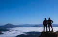 Two mountaineers with sea of clouds and Mount Larun in the background from the natural park of Aiako Harriak, Euskadi Pyrenees Royalty Free Stock Photo