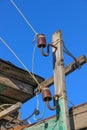 Two mounted on old wooden plank old-fashioned out-of-date ceramic insulators for a hand-made electric line