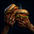 Dirty hands holding two hamburgers on a black background