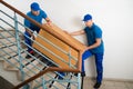 Two Movers With Box On Staircase Royalty Free Stock Photo