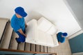 Two Movers Carrying Sofa On Staircase Royalty Free Stock Photo