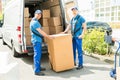 Two Movers Loading Boxes In Truck Royalty Free Stock Photo