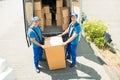 Two Movers Loading Boxes In Truck Royalty Free Stock Photo