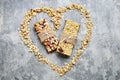 Two muesli bars on grey stone background