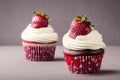 Two muffin cupcakes with vanilla cream and strawberry in red dotted paper baking dish Royalty Free Stock Photo