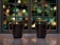 Two mugs with a hot drink - tea or coffee on the window sill of the window. Outside, beautiful background blur, festive lights Royalty Free Stock Photo