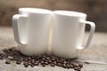 Two Mugs Resting on Roasted Coffee Beans Ready for Morning Coffee Royalty Free Stock Photo