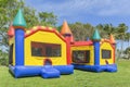 Two multi-color castle bounce houses are ready for the kids