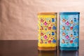 Two multi-colored metal cans for bulk products Royalty Free Stock Photo