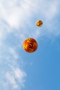 Two multicolored balloons in a blue sky with clouds view from below Royalty Free Stock Photo