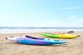 Two multicolored canoes on the beach