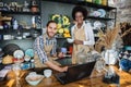 Two multicultural people working on laptop during inventory