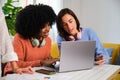 Two multiethnic female college students studying together at home. Royalty Free Stock Photo