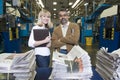 Two Multiethnic Operators In Newspaper Factory Royalty Free Stock Photo